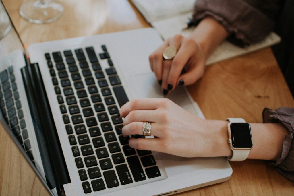 A person engaged in typing on a laptop illustrating dedication in an email marketing agency setting.6